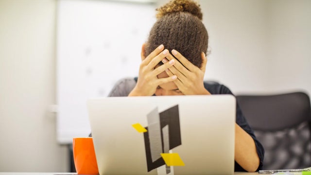 Businesswoman frustrated by bad new at office desk 