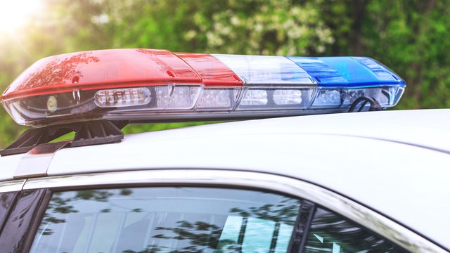 Police patrol car with sirens off during a traffic control. Blue and red flashing sirens of police car during the roadblock in the city. 