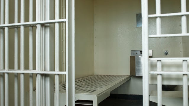 Open door to prison cell 