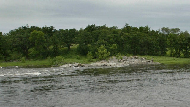 7/2005 U.S. Canadian border near Int'l Falls MN-Deputy Sherrif Bruce Grothberg stands at an area along the U.S. side of the Rainy River as he monitors the Canadian/U.S. dividing line. The River is definately crossable in about 60 seconds and is very remot 